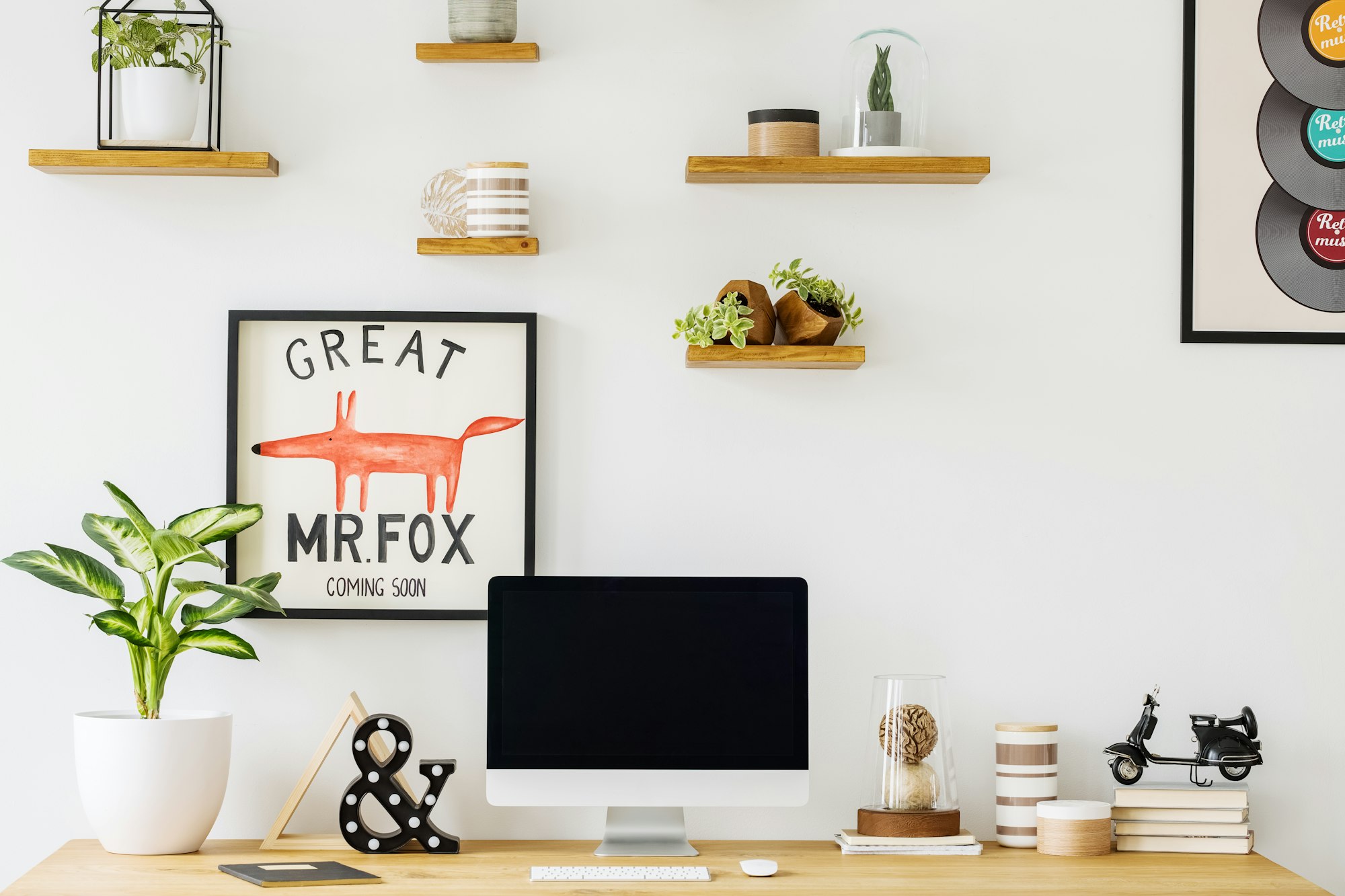 Plant and desktop computer on wooden desk in freelancer's interi